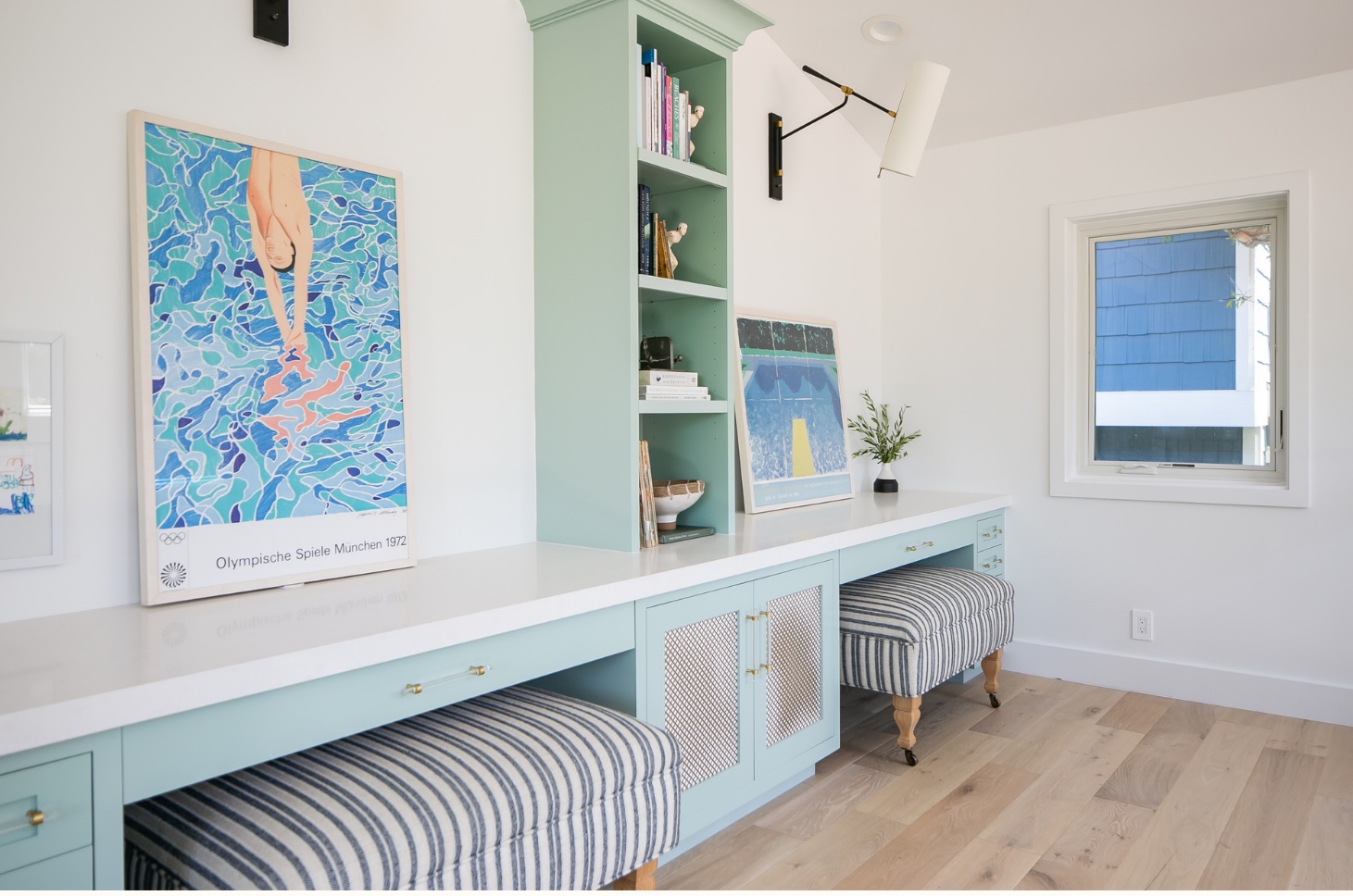 Study with mint green built-in desk, striped benches and vintage Olympic posters