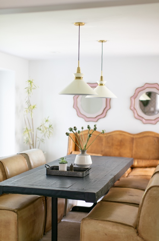Dining table with cream pendants and leather banquette