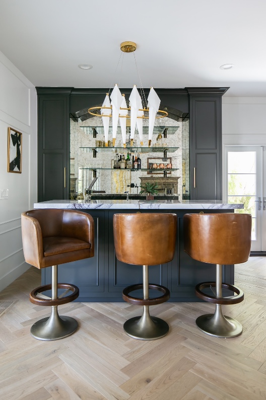 Bar seating on herringbone oak with sculptural chandelier