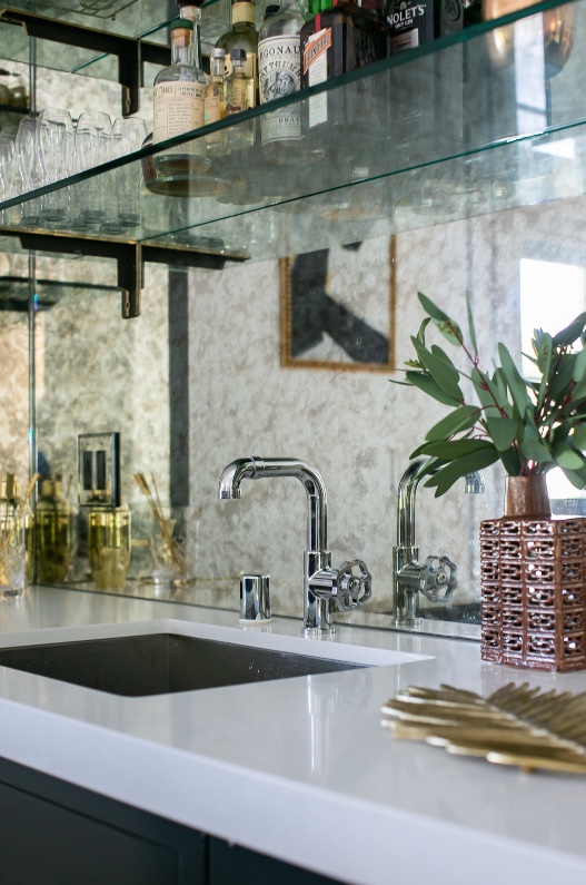 Bar sink with antiqued mirror backsplash and glass shelves