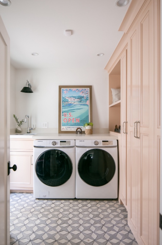 Laundry room with blush millwork and patterned cement tile