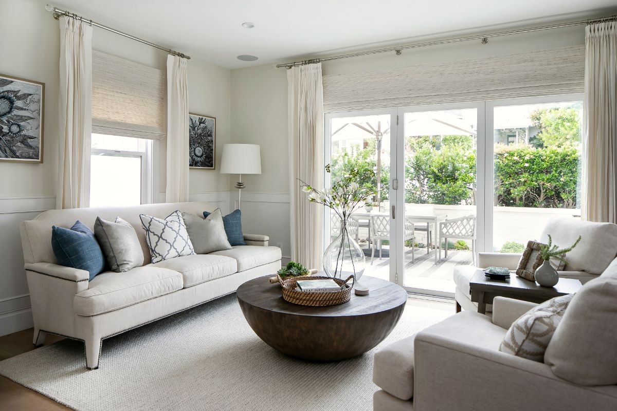 Living room in soft whites with French doors open to the garden