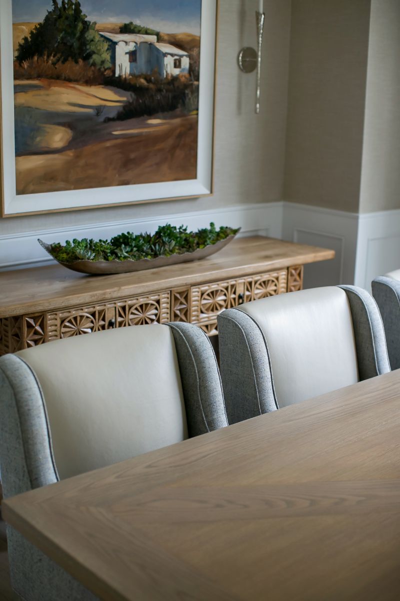 Dining detail with carved console and coastal painting