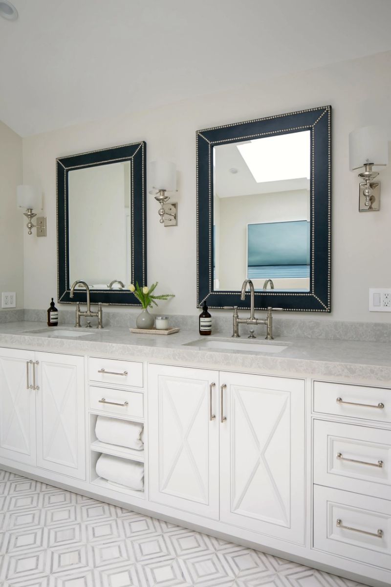 Double vanity with dark framed mirrors