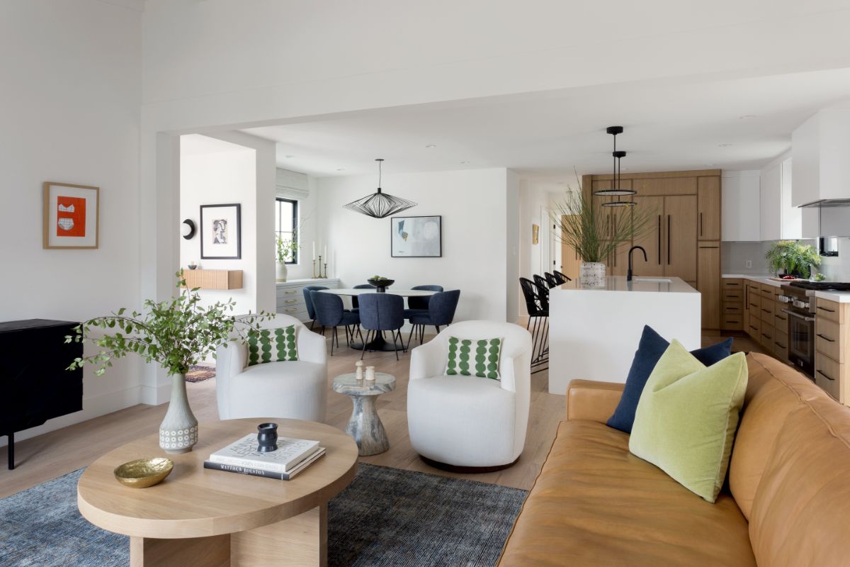 Open living and dining area with leather sofa and round oak coffee table
