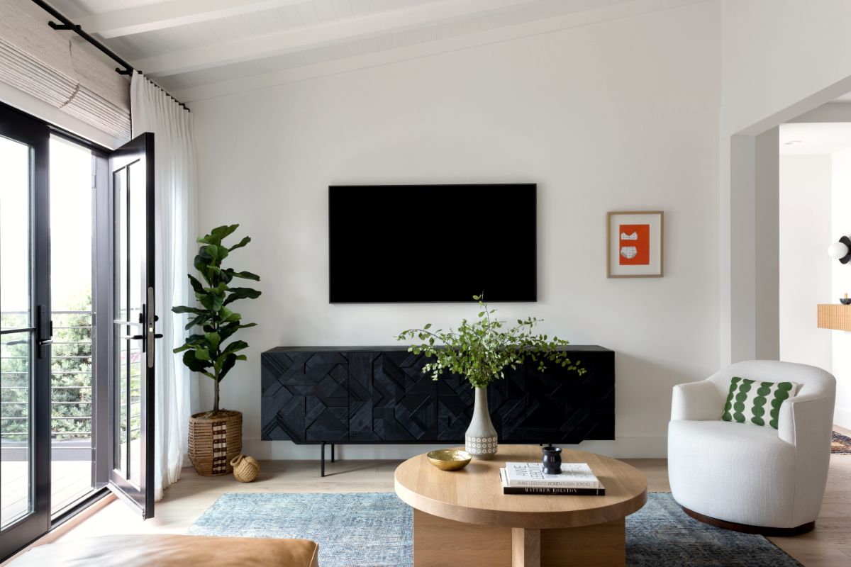 Living room with carved dark sideboard and black steel doors