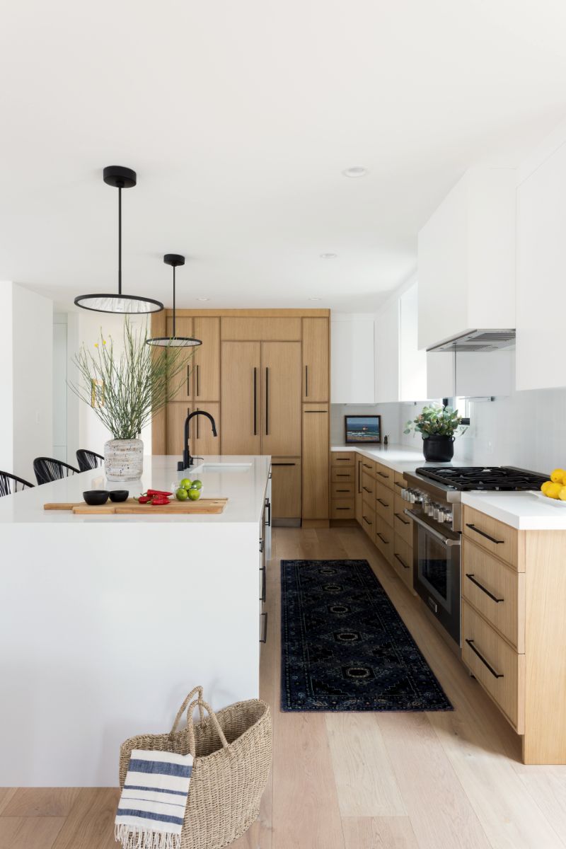 Galley view of the kitchen with oak cabinetry and runner
