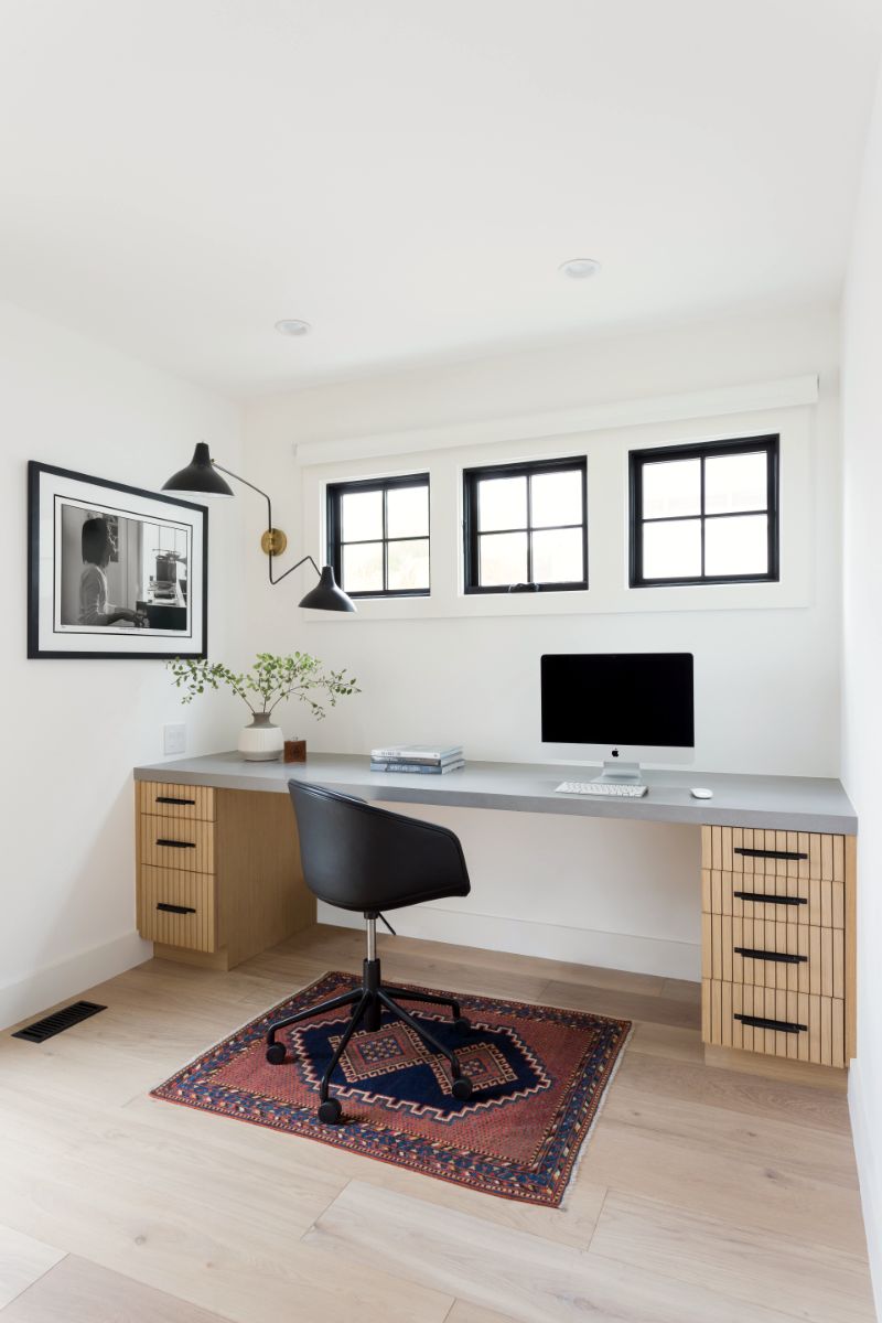Home office with built-in oak desk and vintage rug