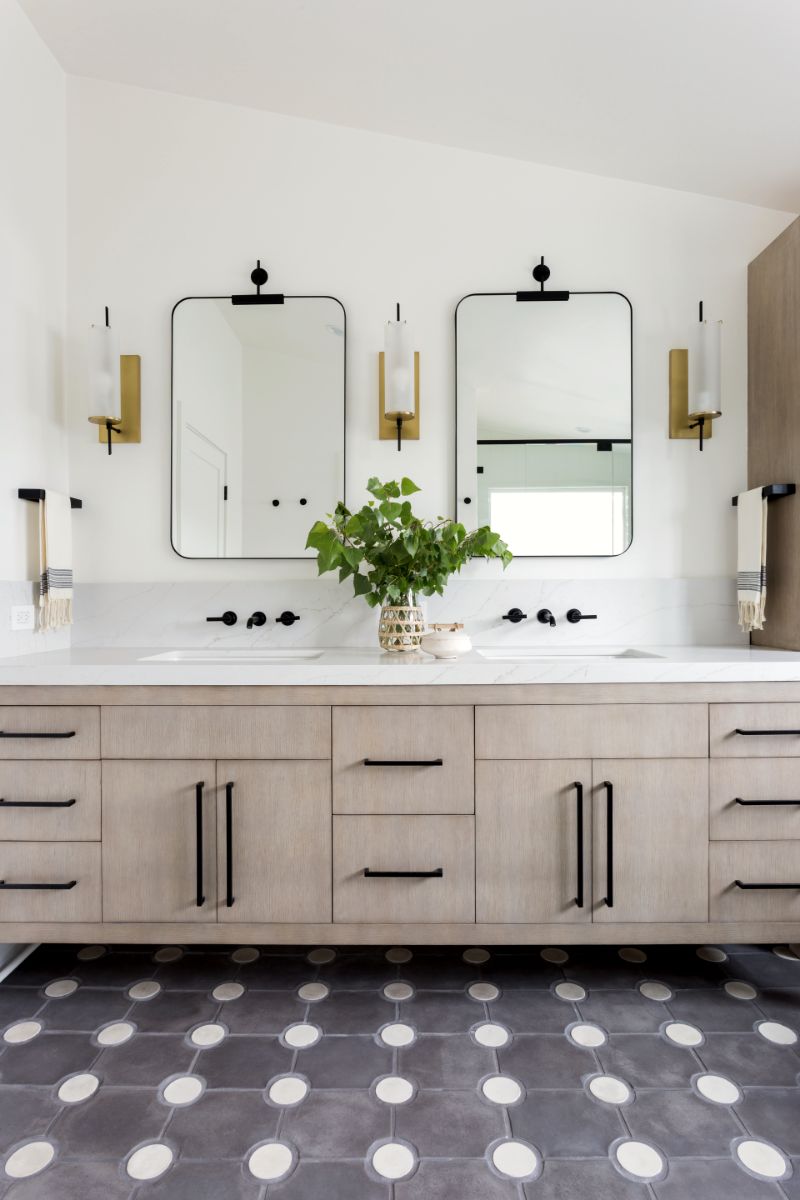Double oak vanity with round mirrors and brass sconces