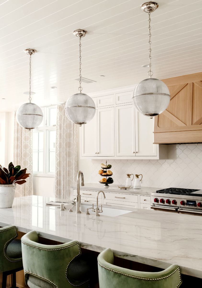 Kitchen island with marble top and sage velvet stools