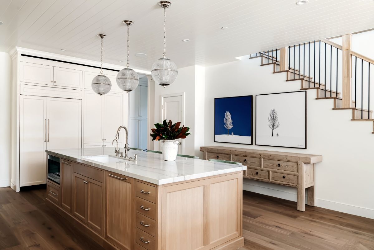 Open kitchen with oak island and staircase beyond