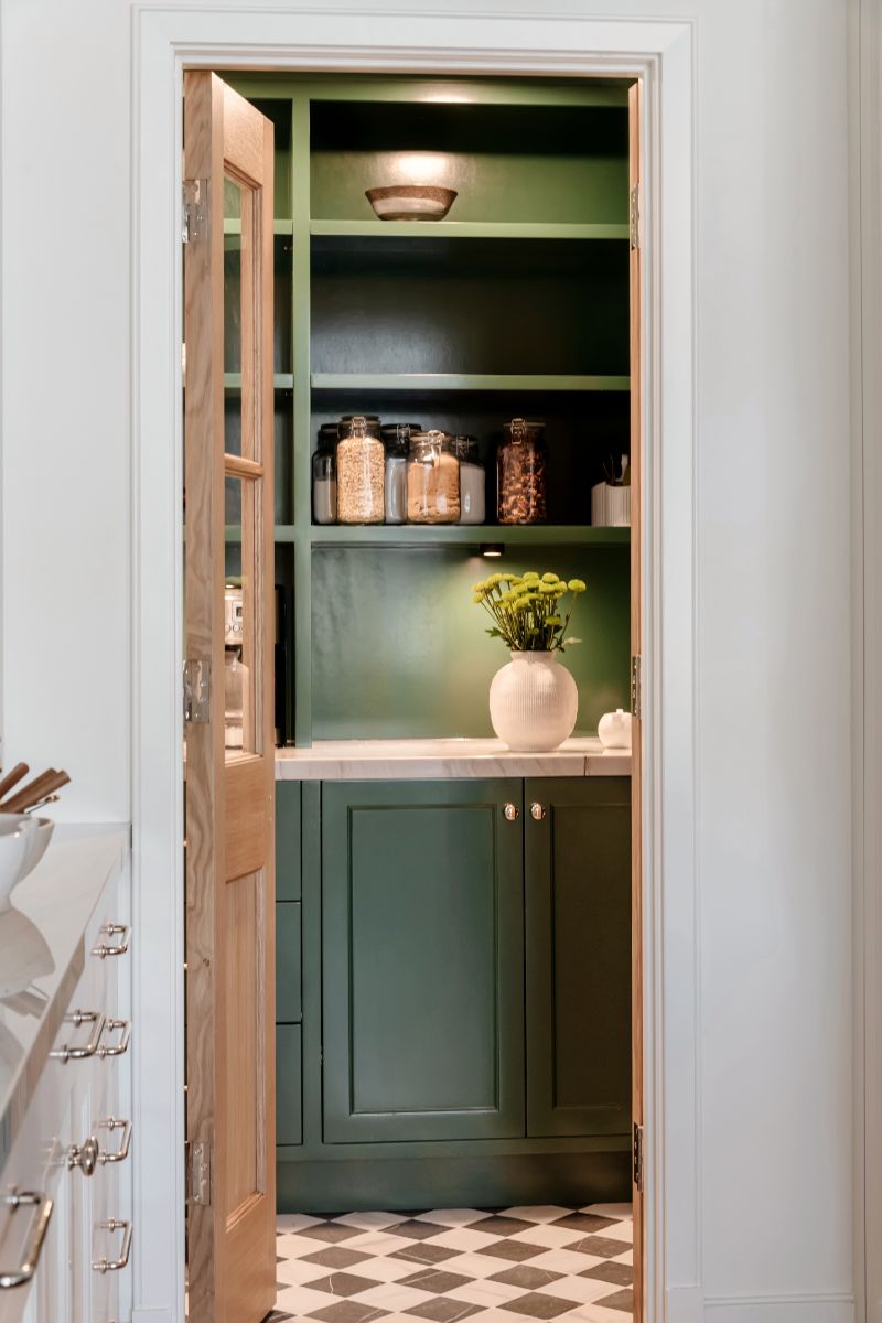 Emerald lacquered pantry with checkerboard floor