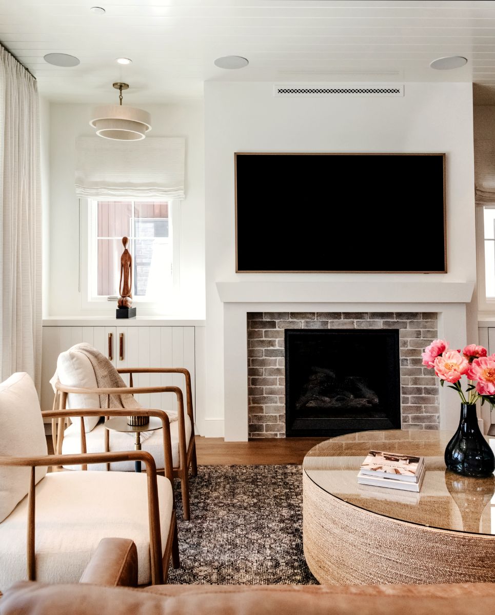 Living room with painted-brick fireplace and woven coffee table