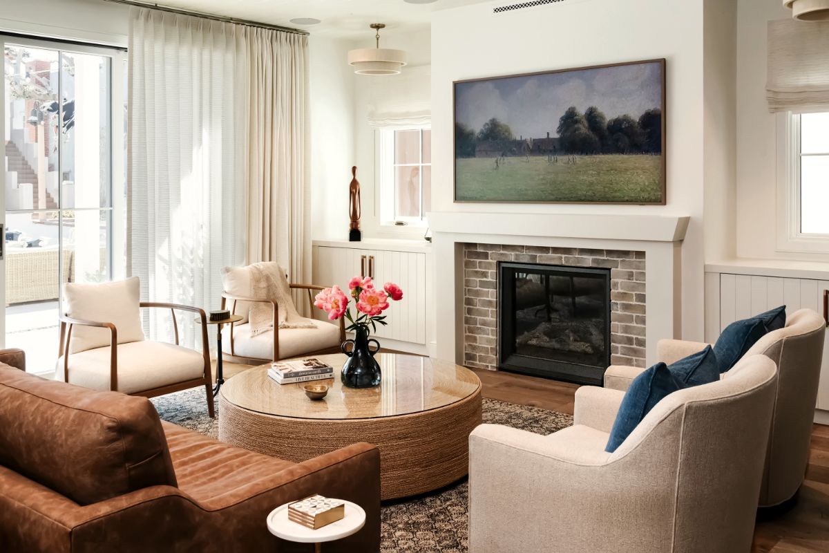 Sitting room with leather sofa, blue pillows and fireplace