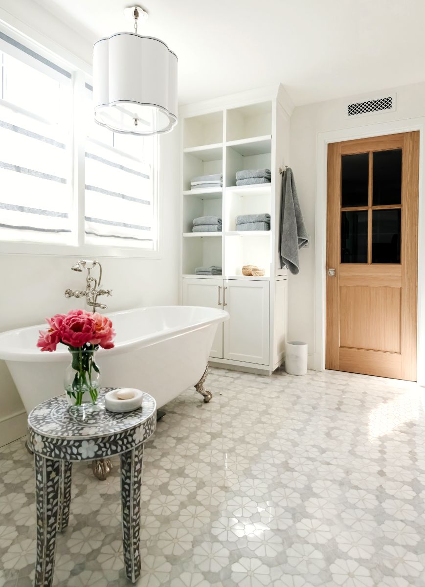 Primary bath with clawfoot tub and built-in shelving